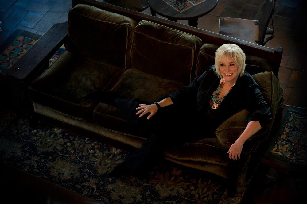 Betty Buckley relaxing on a velvet sofa